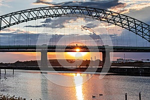 Silver Jubilee Bridge in Runcorn with the sun setting in the background