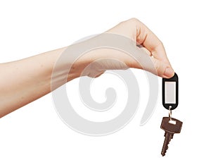 Silver key with blank tag in hand