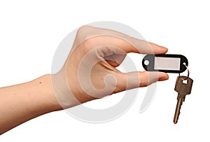 Silver key with blank tag in hand