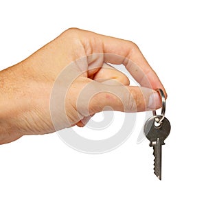 Silver key in a hand.