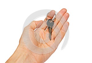 Silver key in a hand.