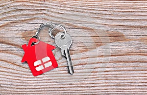 Silver key with red house figure