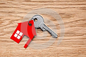Silver key with red house figure