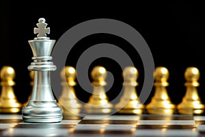 Silver king chess piece face with gold team on black background Concept for company strategy, business decision and encounter the