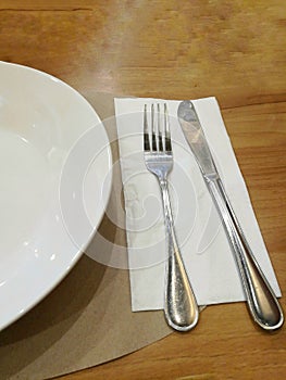 Silver knife, fork and the white dish