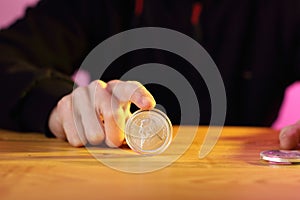 A silver krugerrand on a table pressed down