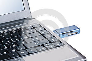Silver laptop with usb flash drive