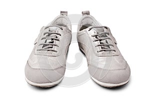 Silver leather sneakers white background isolated close up front view, stylish light gray suede gumshoes, pair of beige shoes