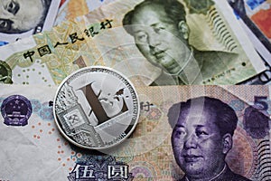 Silver Litecoin LTC on Chinese Yuan and US dollars banknotes