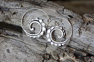 Metal decorative oriental spirale design earrings on natural neutral background