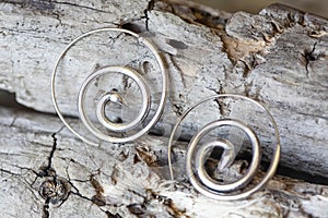 metal decorative oriental spirale design earrings on natural neutral background photo