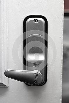 Silver door lock on white door