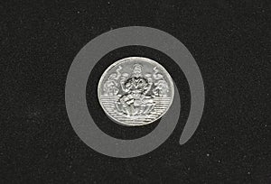 silver metal Lakshmi coin. photo