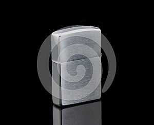 Silver metal lighter  on a black background