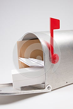 silver metal mailbox open with mails and package