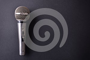 Silver metal microphone on black table top view