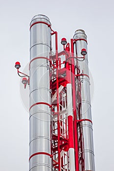 Silver metal pipe on a bright red iron frame
