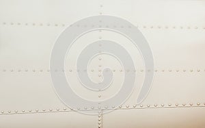 Silver metal surface of the aircraft fuselage with rivets photo