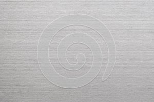 Silver metal texture of brushed stainless steel plate with the reflection of light.