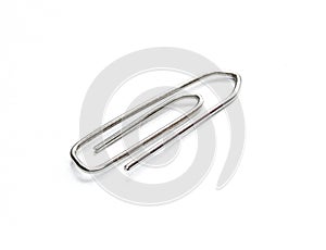 Silver metallic paperclip isolated on white background.