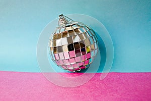 Silver mirror musical club disco ball xmas festive Christmas ball, Christmas toy plastered on glitter gray pink purple background