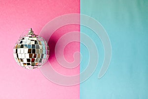 Silver mirror musical club disco ball xmas festive Christmas ball, Christmas toy plastered on glitter gray pink purple background
