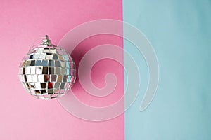 Silver mirror musical club disco ball xmas festive Christmas ball, Christmas toy plastered on glitter gray pink purple background