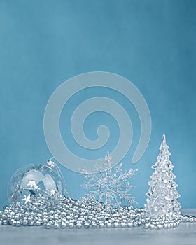 Silver monochrome Christmas ornaments on blue