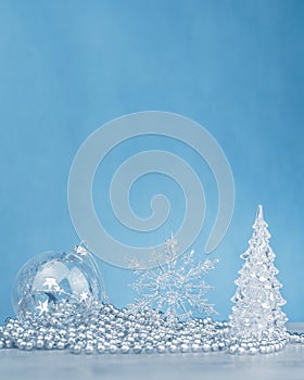 Silver monochrome Christmas ornaments on blue