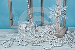 Silver monochrome Christmas ornaments on blue