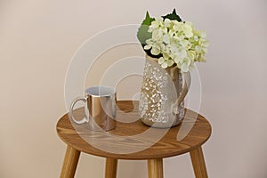 Silver mug over wooden table