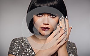 Silver nail art polish manicure. Short bob hair woman model. Fashion brunette close up portrait with beauty makeup and glossy man