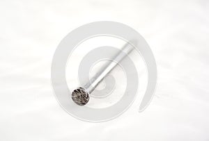 Silver nails on white.