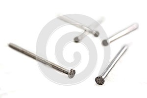 Silver nails on white.