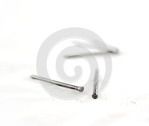 Silver nails on white.