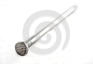 Silver nails on white.