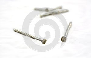 Silver nails on white.