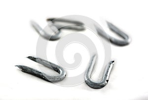 Silver nails on white.