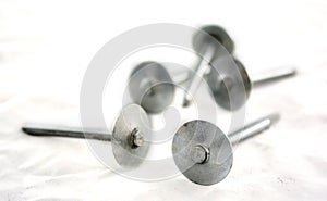 Silver nails on white.