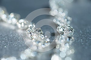 Silver necklace with diamonds close-up in defocus on a light background