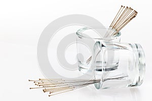 Silver needles for traditional Chinese acupuncture medicine. White background. Full depth of fieldm.