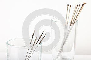 Silver needles for traditional Chinese medicine acupuncture. Close-up. White background.