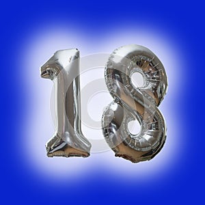 Silver number 18 party balloons isolated on a blue background