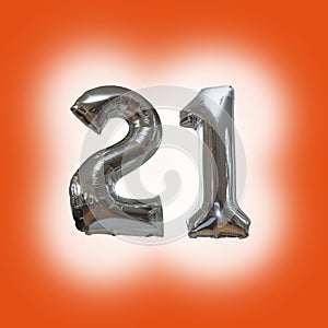 Silver number 21 party balloons isolated on a blue background