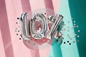 Silver numbers 10 ten percent balloons in pink turquoise background