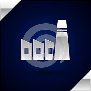 Silver Oil and gas industrial factory building icon isolated on dark blue background. Vector Illustration