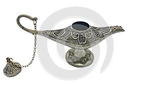 Silver open Aladdins lamp on a white background. Ornamental textured old metallic lamp with chain and cap. Antique style