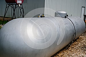 Silver painted liquid propane tank on rural property