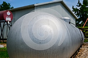 Silver painted liquid propane tank on rural property