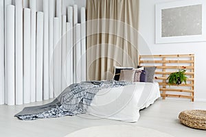 Silver painting in sophisticated bedroom